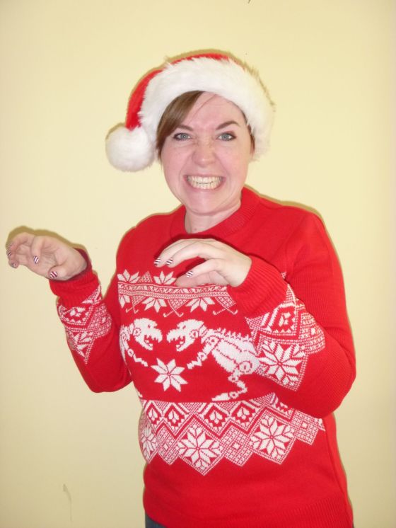It's a DINOSAUR CHRISTMAS JUMPER!